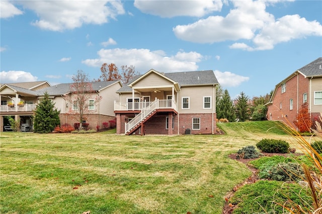 rear view of house featuring a yard, a deck, ceiling fan, and cooling unit