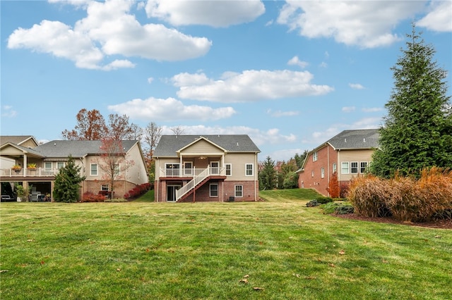 rear view of property featuring a lawn