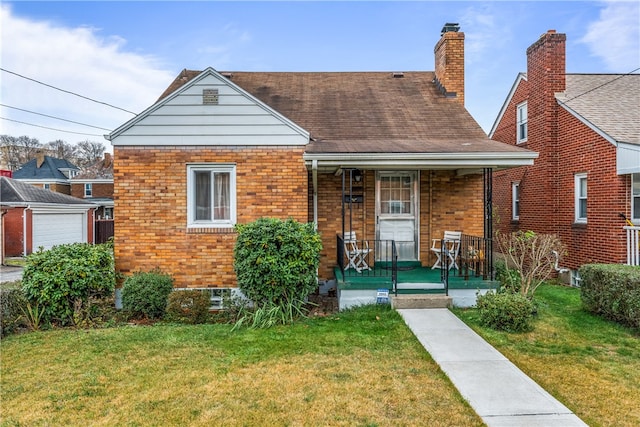 bungalow with a front yard and a porch