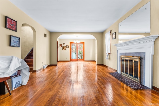 unfurnished living room with a fireplace and hardwood / wood-style floors