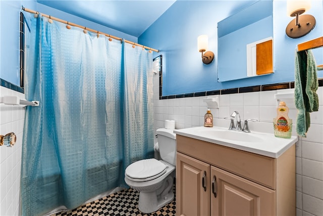 full bathroom featuring vanity, tile patterned flooring, toilet, shower / bath combo with shower curtain, and tile walls