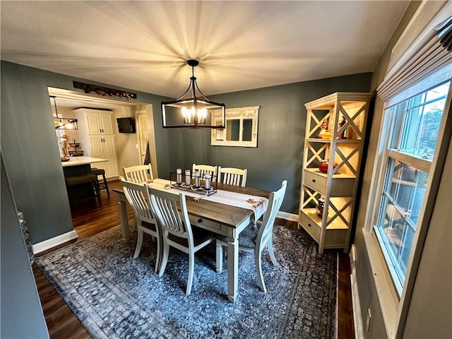 dining room with a chandelier and dark wood-type flooring