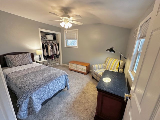 carpeted bedroom with ceiling fan and a closet