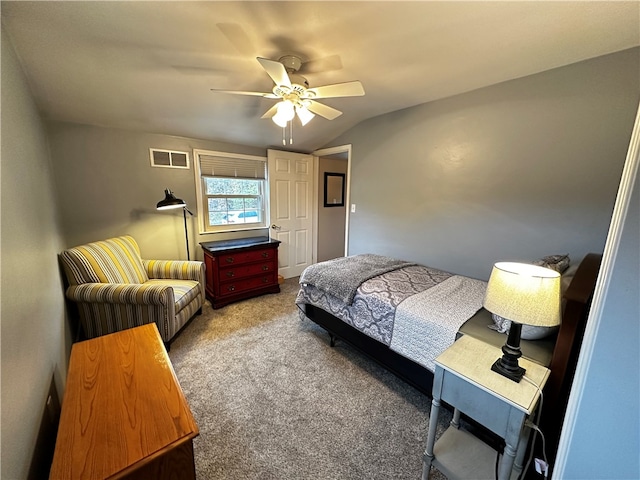 bedroom with ceiling fan, carpet floors, and vaulted ceiling