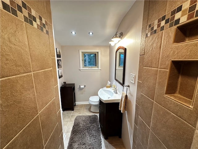 bathroom with tile patterned flooring, vanity, and toilet