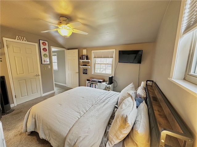 carpeted bedroom with ceiling fan and vaulted ceiling