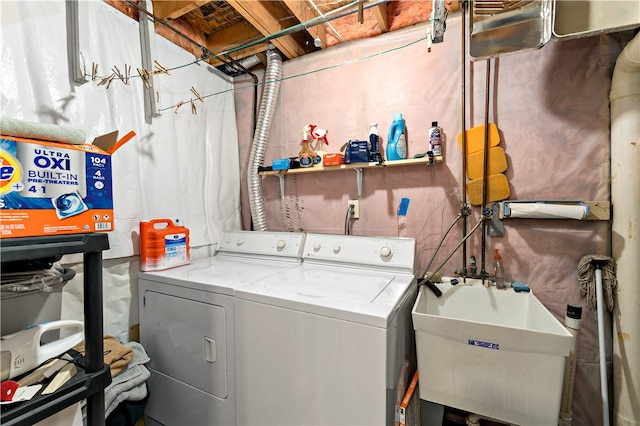 washroom with washer and clothes dryer and sink