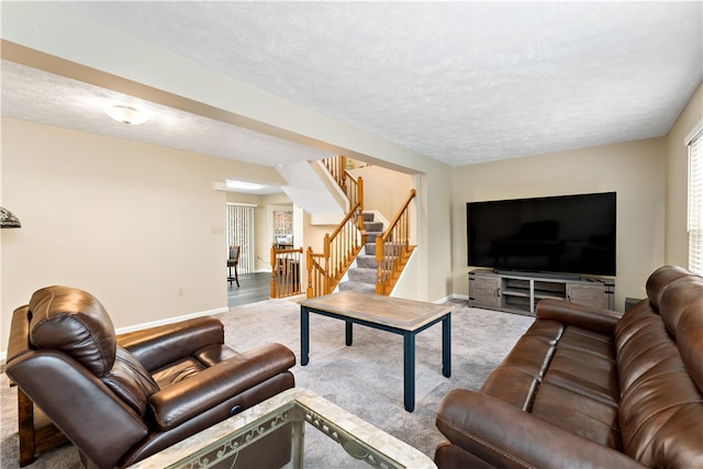 living room featuring a textured ceiling and carpet floors