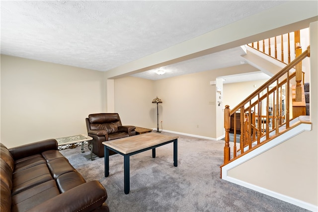 carpeted living room featuring a textured ceiling