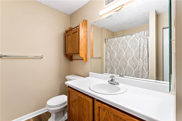 bathroom featuring hardwood / wood-style floors, vanity, and toilet