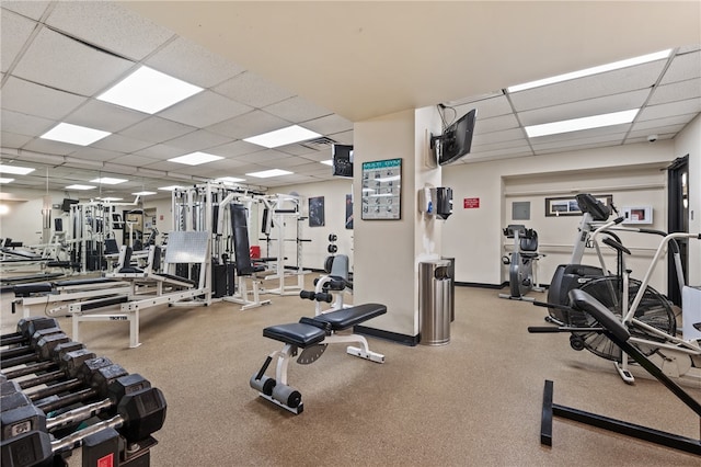 exercise room with a paneled ceiling