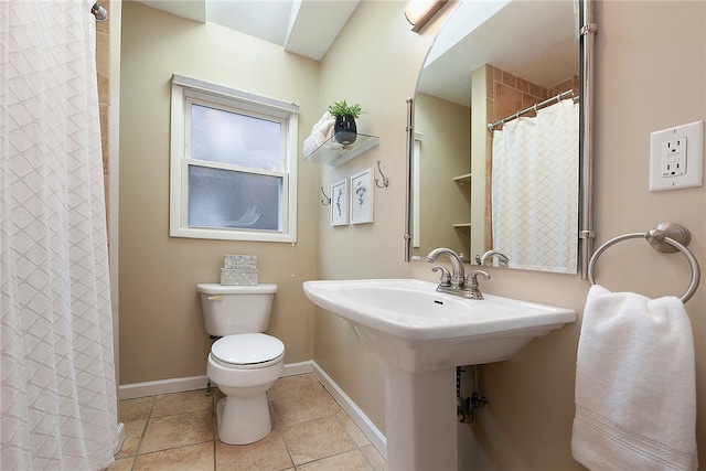 bathroom with tile patterned floors, a shower with curtain, toilet, and sink