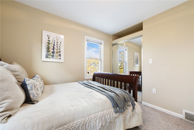 carpeted bedroom with a closet