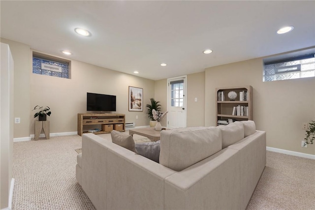 living room with light carpet and a baseboard heating unit