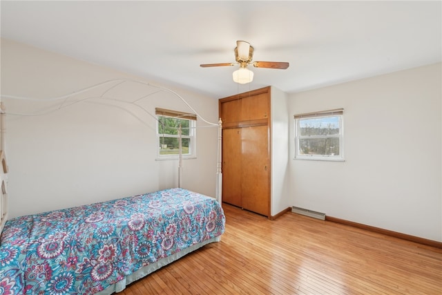 bedroom featuring light hardwood / wood-style flooring and ceiling fan