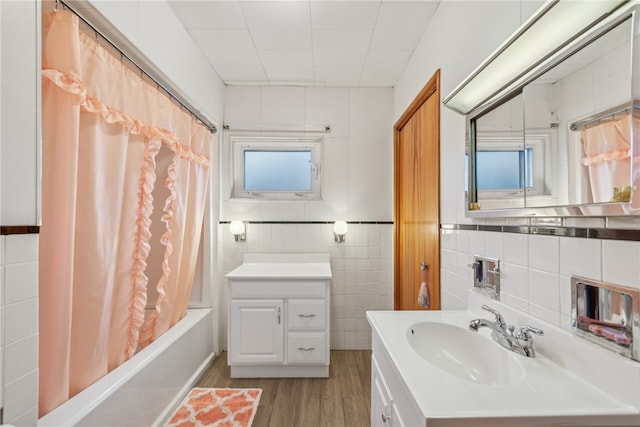 bathroom featuring plenty of natural light, vanity, tile walls, and hardwood / wood-style flooring