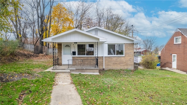 bungalow with a porch and a front yard