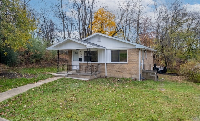 bungalow-style house featuring a front lawn and a porch