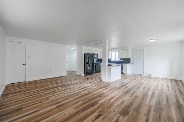 unfurnished living room with light hardwood / wood-style floors