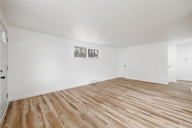 empty room with light hardwood / wood-style flooring