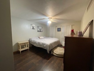 bedroom featuring ceiling fan and dark wood-type flooring