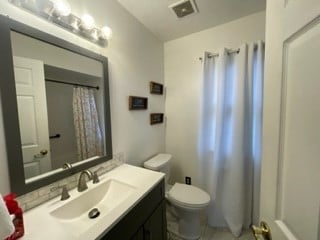 bathroom featuring vanity and toilet