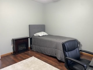 bedroom with dark wood-type flooring