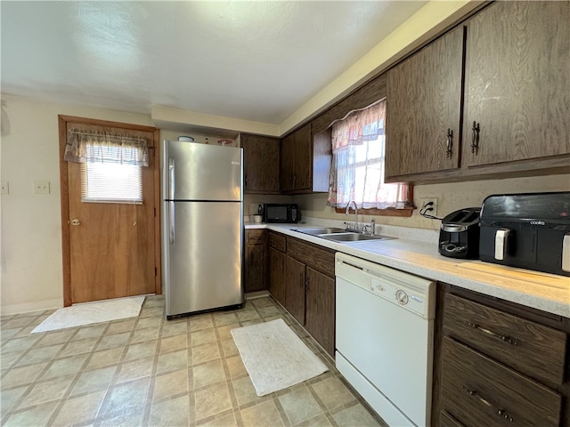 kitchen with stainless steel fridge, dishwasher, a healthy amount of sunlight, and sink