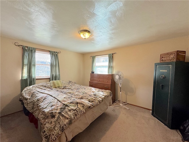 carpeted bedroom featuring a textured ceiling