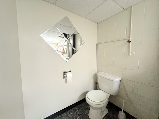 bathroom featuring toilet and a drop ceiling