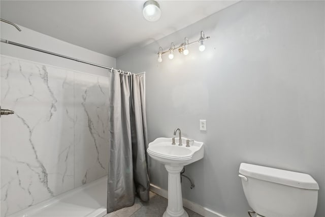 bathroom featuring a shower with shower curtain, toilet, and tile patterned floors