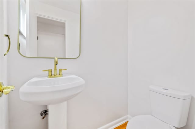 bathroom with toilet and wood-type flooring