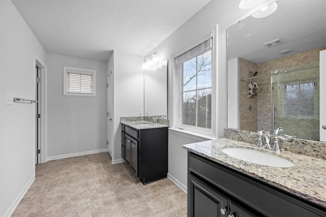 bathroom with vanity and a shower with door