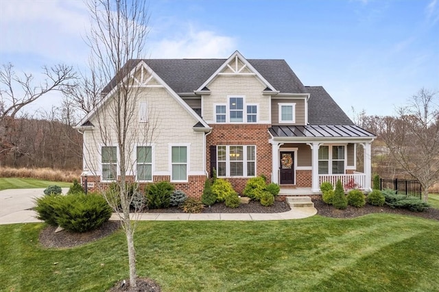 craftsman inspired home with covered porch and a front lawn