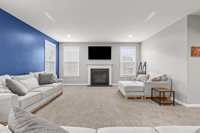 living room with a healthy amount of sunlight and light colored carpet