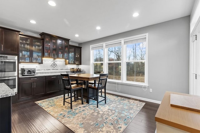 dining area with dark hardwood / wood-style flooring