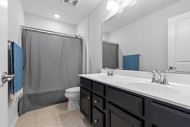 full bathroom with tile patterned floors, shower / tub combo with curtain, vanity, and toilet