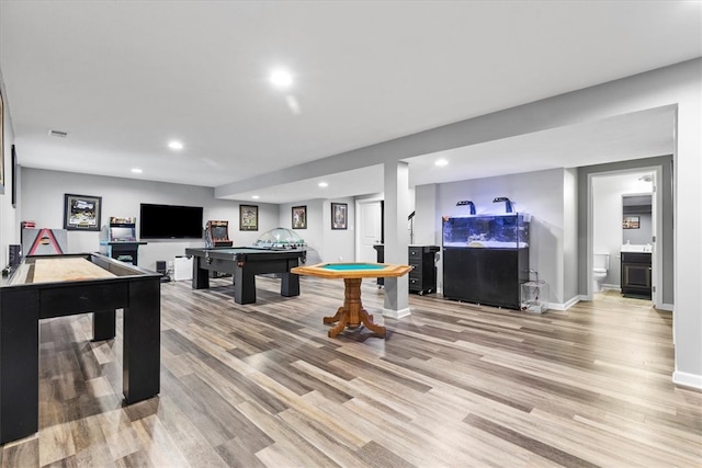 game room with light hardwood / wood-style flooring and pool table