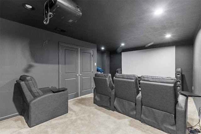 cinema room featuring light colored carpet