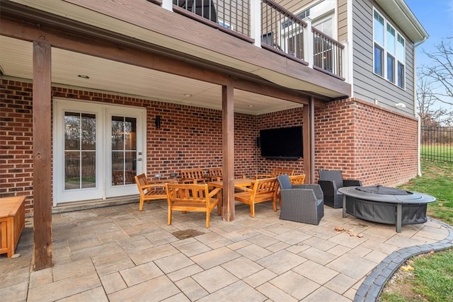 view of patio with an outdoor living space and a balcony