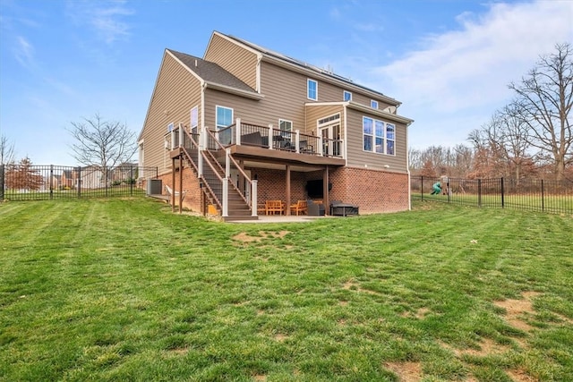 back of property featuring a yard, cooling unit, and a wooden deck