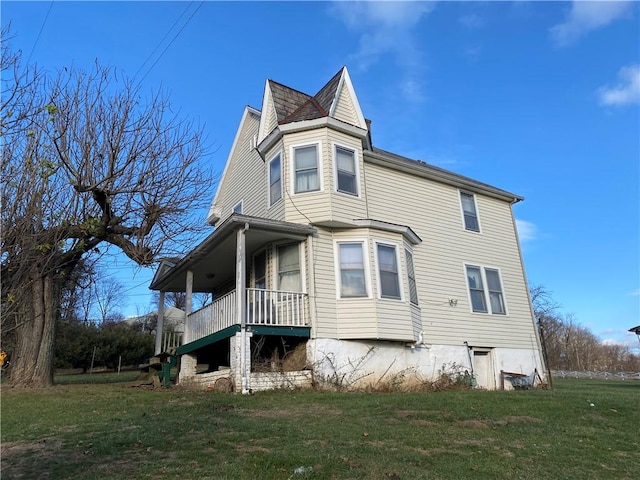 view of side of home with a lawn