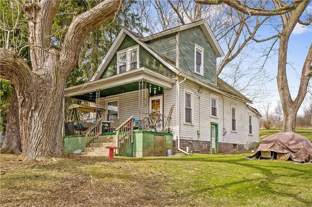 view of front of house with covered porch and a front yard