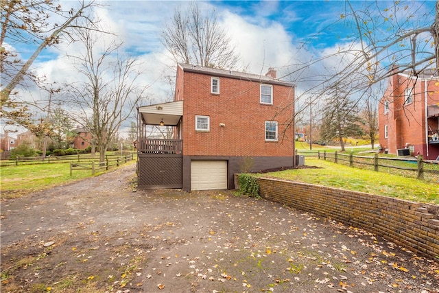 view of side of property with a garage and a deck