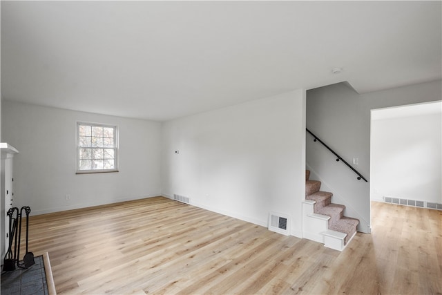 unfurnished living room with light hardwood / wood-style flooring