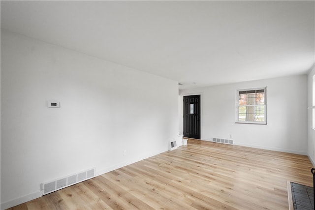 unfurnished room with light wood-type flooring