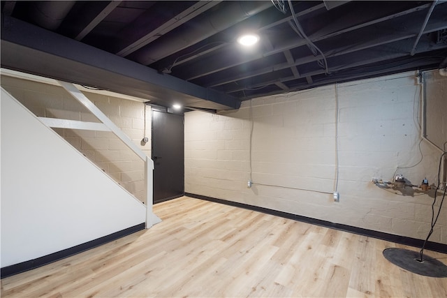 basement with hardwood / wood-style floors