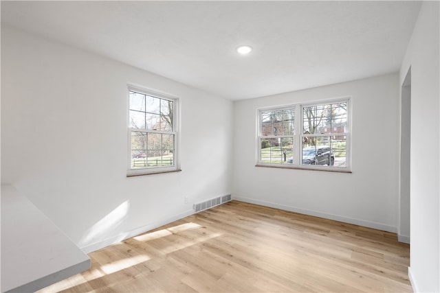 unfurnished room with light hardwood / wood-style flooring