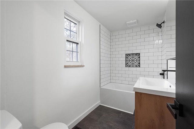 full bathroom with vanity, toilet, and tiled shower / bath