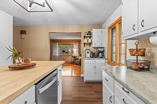 kitchen with dishwasher, wooden counters, dark hardwood / wood-style floors, decorative backsplash, and white cabinets